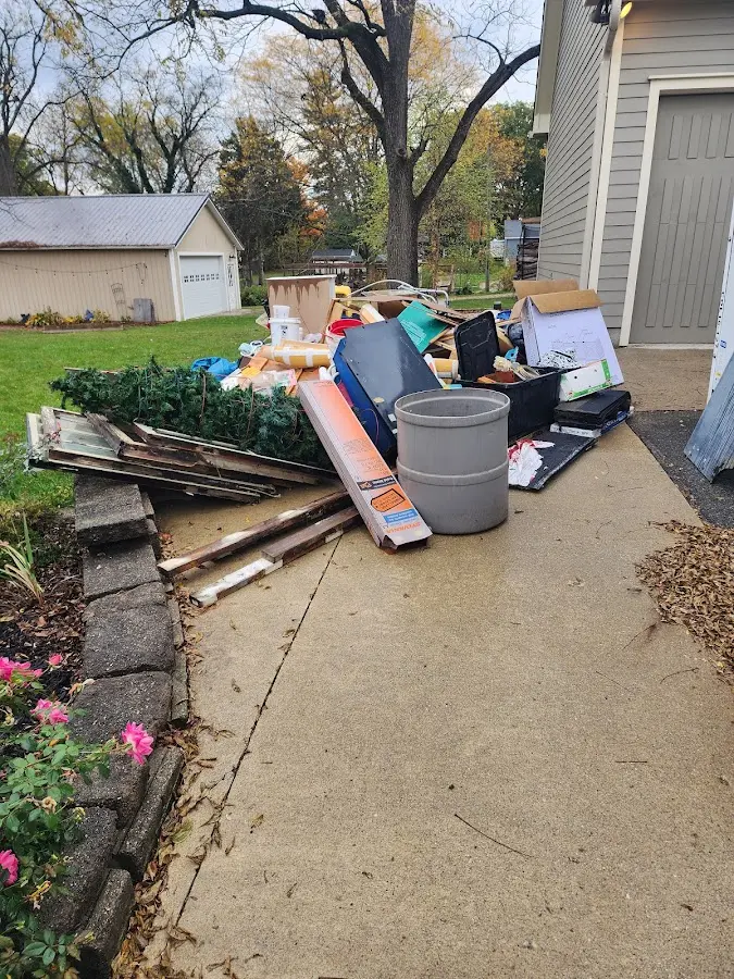 Dumpster being loaded with debris for Estate Cleanout Dumpster Rental in Winnsboro
